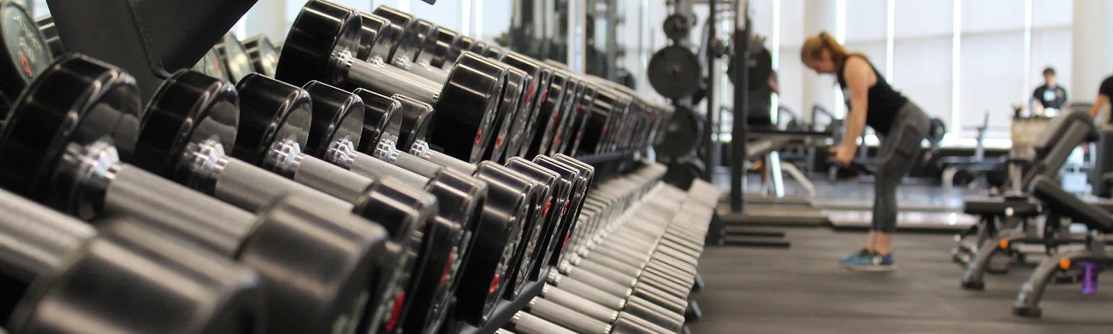 Rows of dumbbells on a rack in a gym