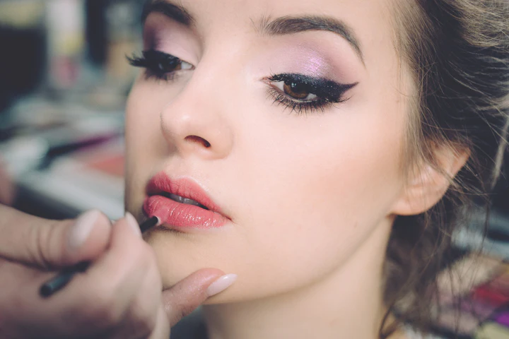 Close-up of a woman applying lip liner