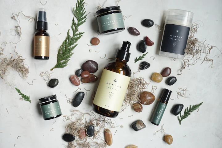 Natural skincare bottles and jars arranged with smooth stones