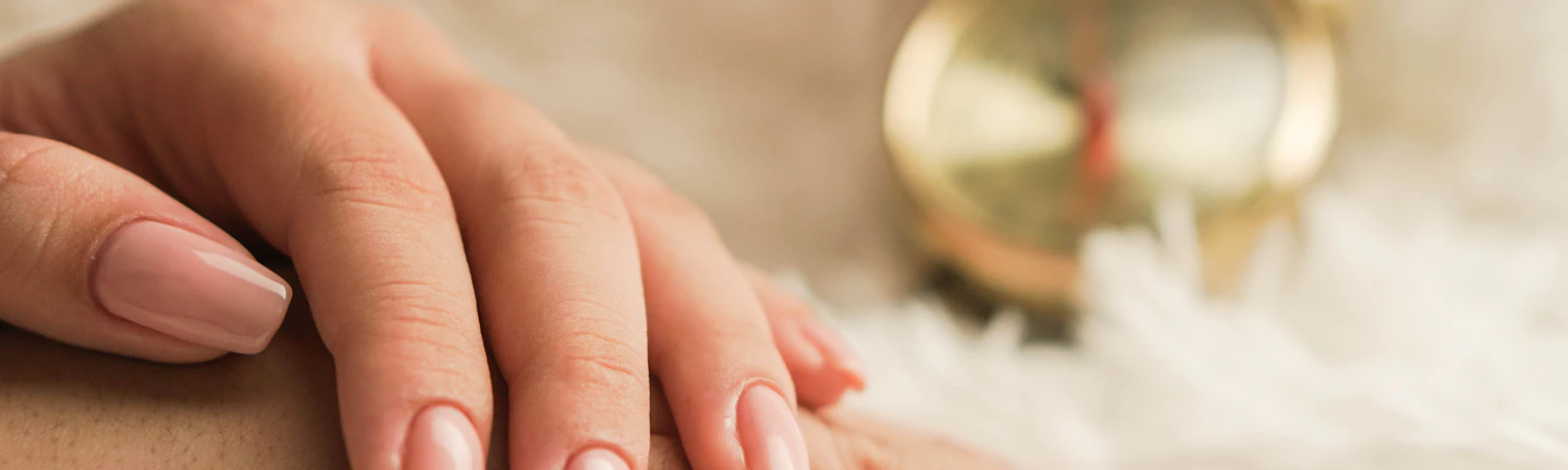 Close-up of hands with neatly manicured glossy pink nails