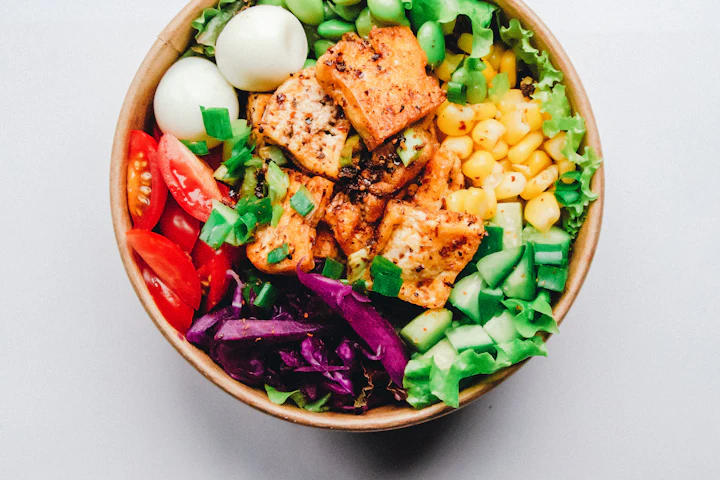 Colorful salmon poke bowl with rice, avocado, and fresh vegetables