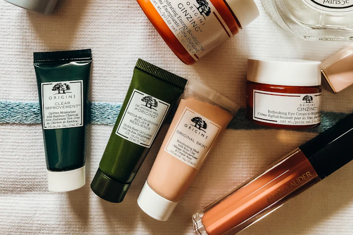 Assorted skincare jars, tubes, and bottles arranged on a light surface